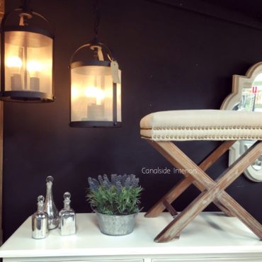 Cream Ottoman with X-Base and Studded Detailing