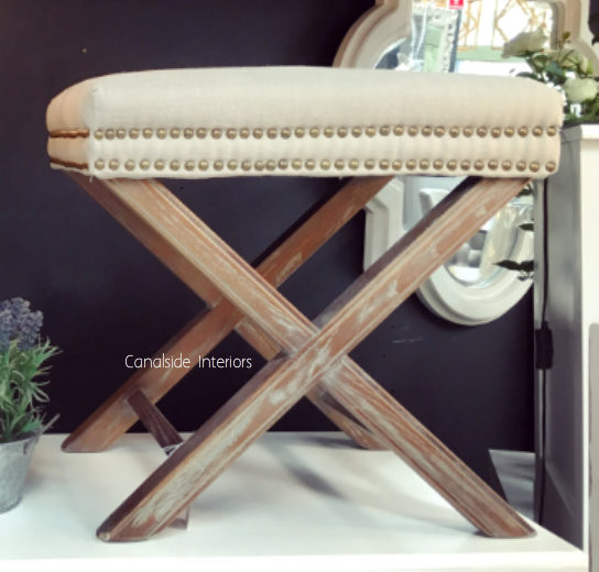 Cream Ottoman with X-Base and Studded Detailing