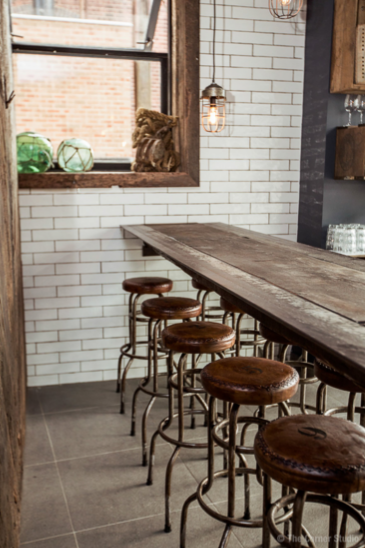 Canalside Interiors' Buck Industrial Stool as featured at Seawall Bar & Restaurant Image C/- seawallrestaurant.com.au